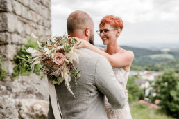 Braut lacht Bräutigam an mit Boho Brautstrauß von Ganz Unverblümt